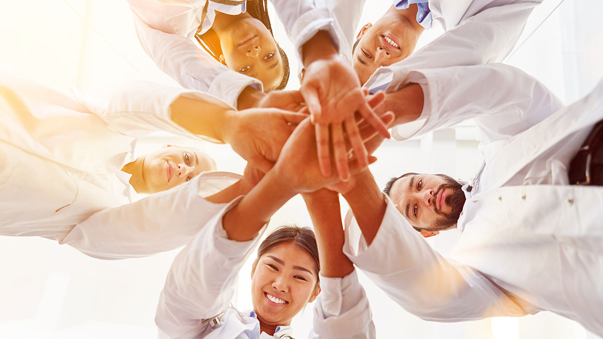 multicultural doctors gathered in a circle of unity