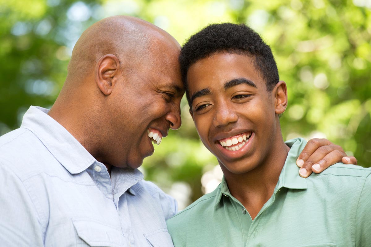 Father and son smiling