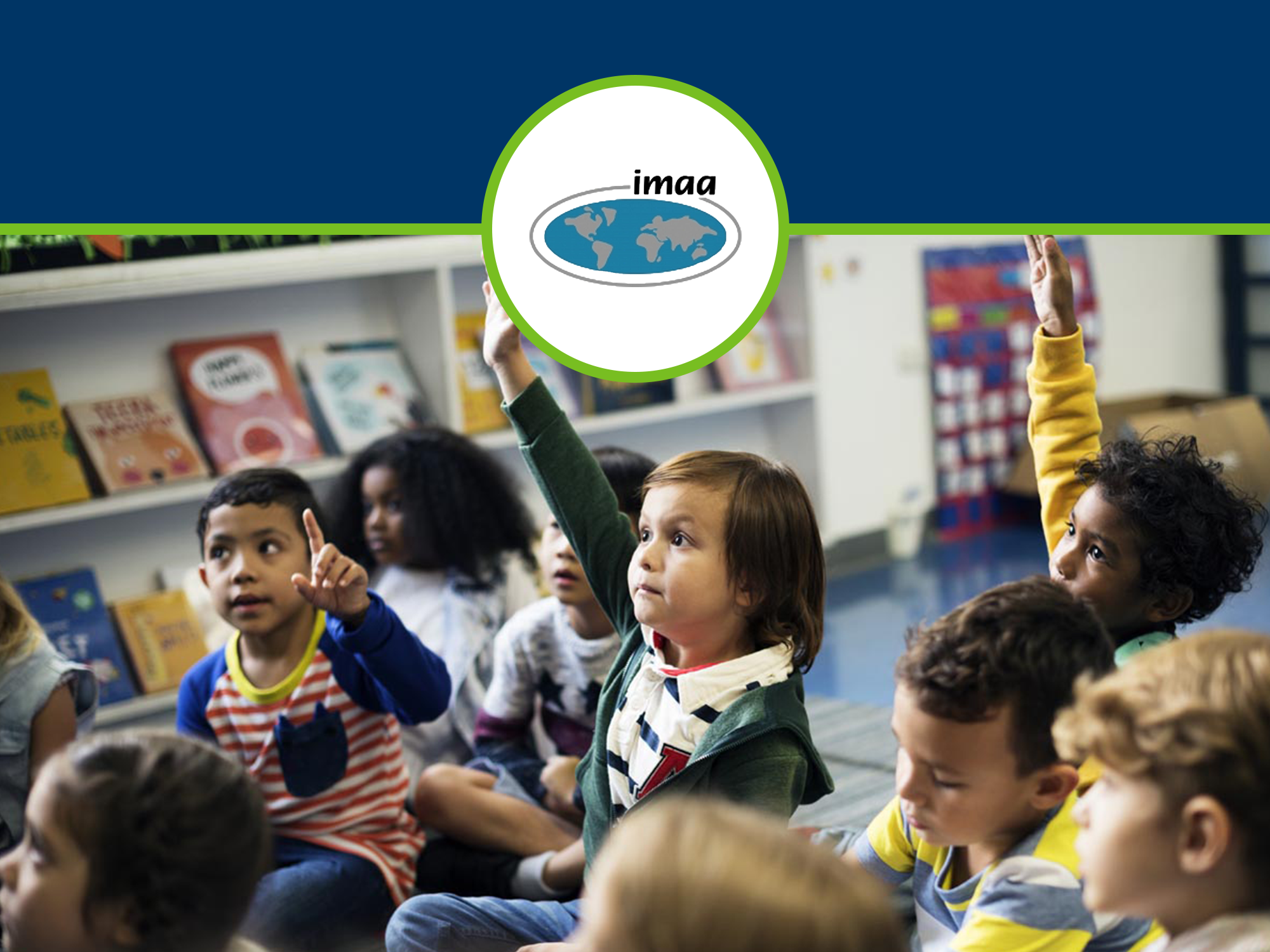 Elementary school student raising hand in group of students