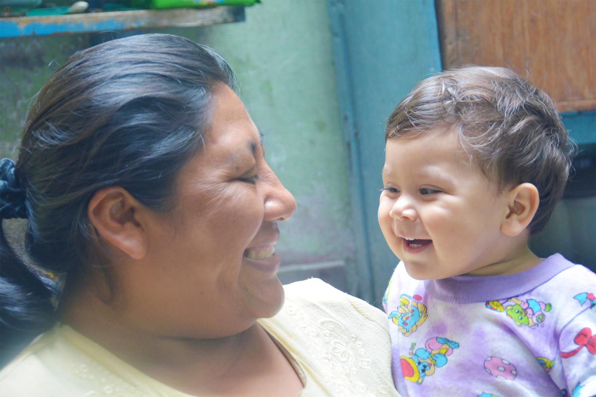 American Indian woman smiling with her infant child