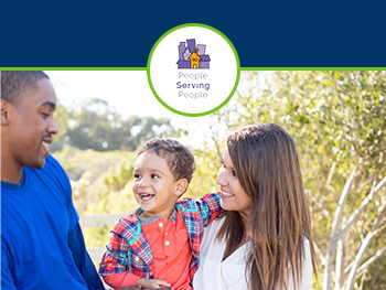 Young family with infant smiling in park