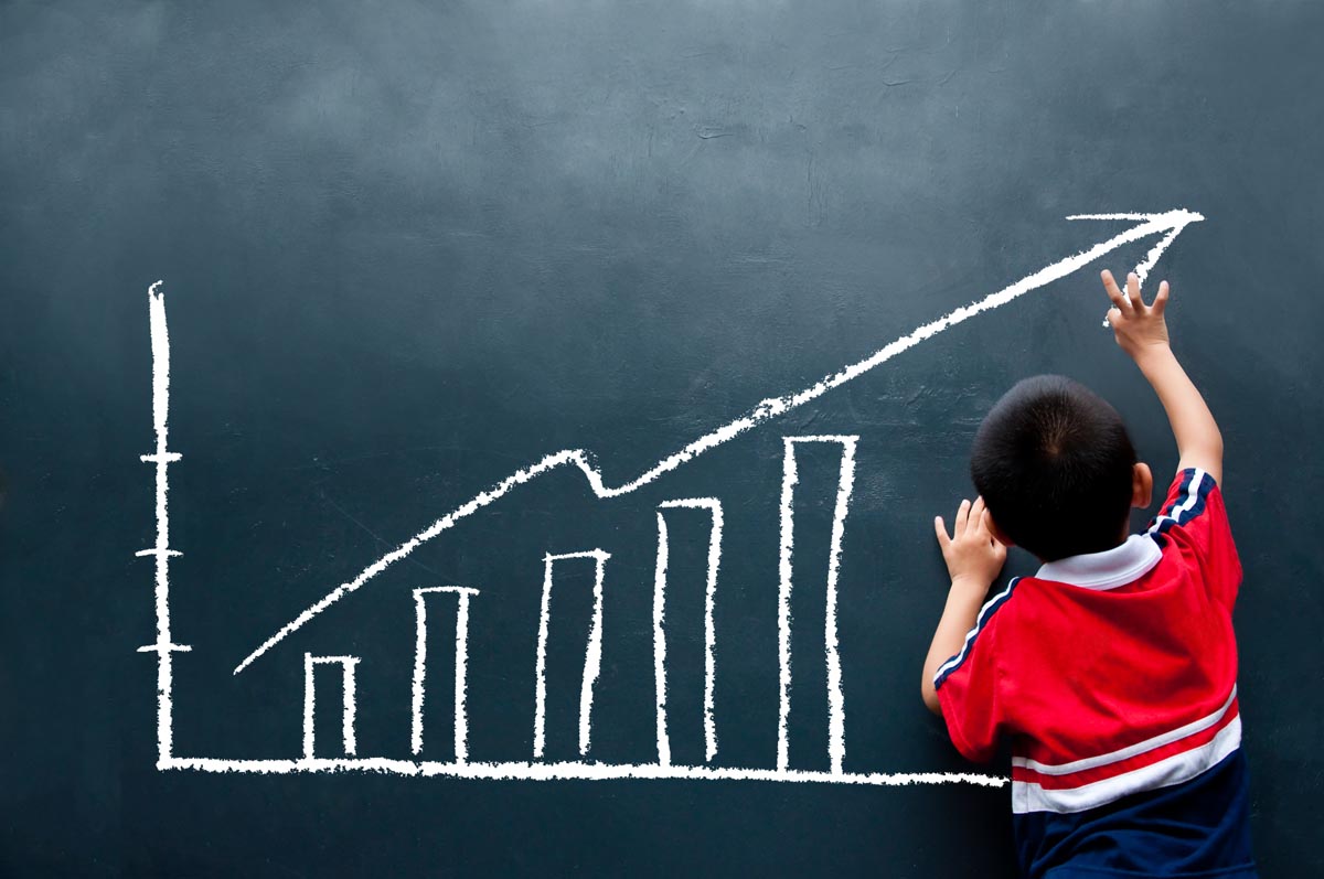 Child drawing graph on chalk board