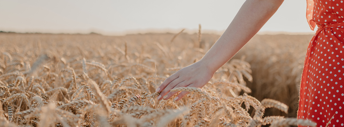 woman walking through a wheat field