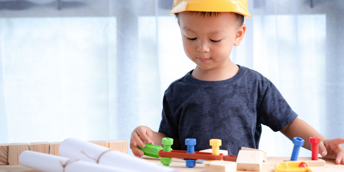 boy playing with toy tools