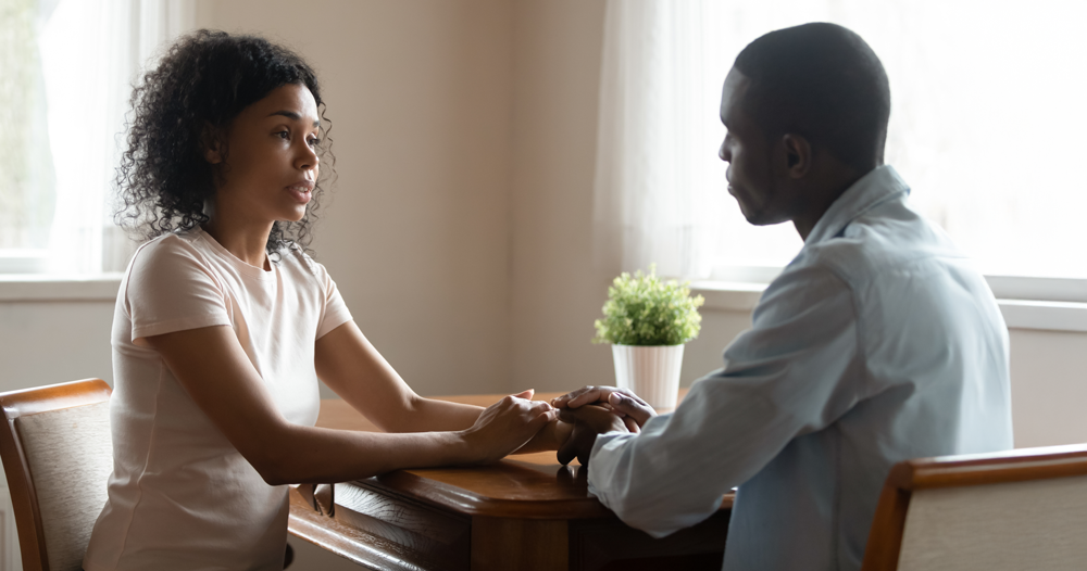 two people talking at table